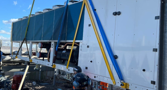 New ASHP being crane lifted into position.