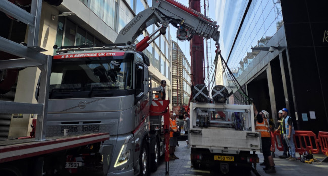 Prefabricated pipework support modules being unloaded for crane lift.